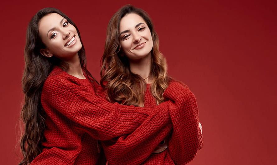 Two Women Wearing Red Hugging